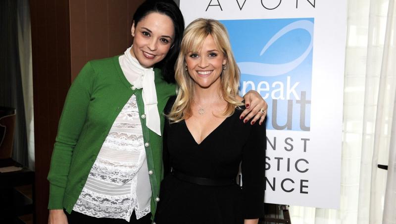 Andreea Marin și actrița Reese Witherspoon, la o conferință despre violența domestică. Andreea Marin poartă un pulover verde, peste o cămașă albă, iar actrița poartă o rochie neagră