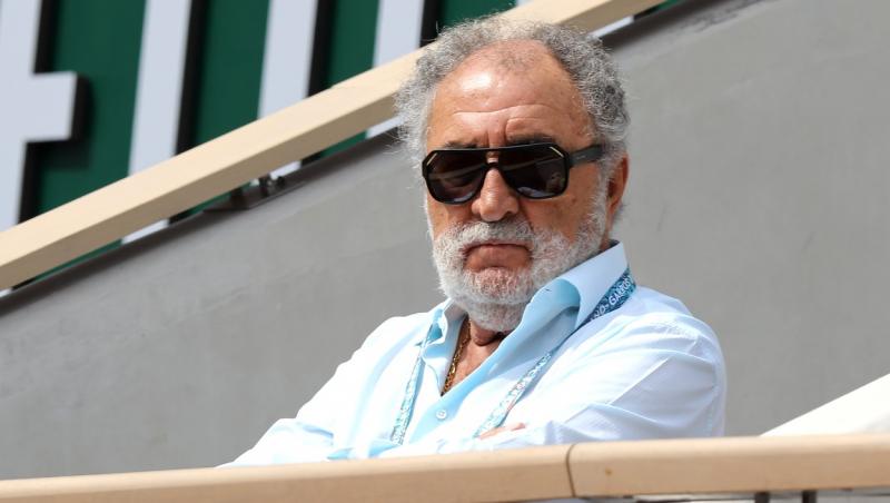 ion tiriac cu ochelari de soare si camasa albastra